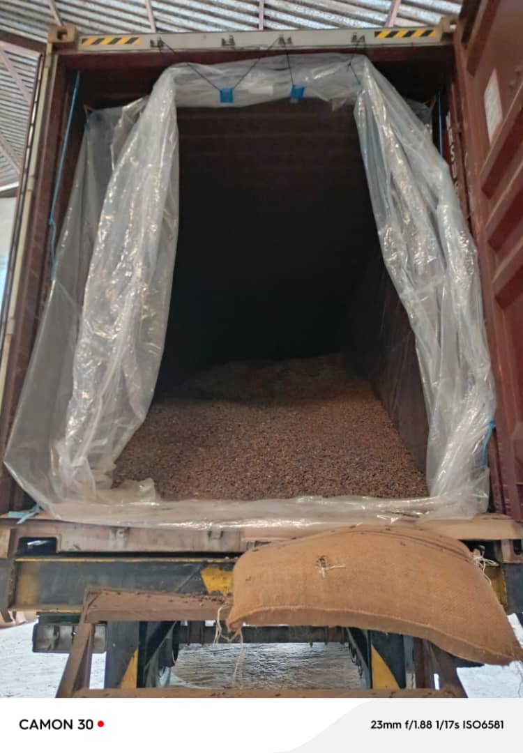 Warehouse worker carrying a bagged commodity sack