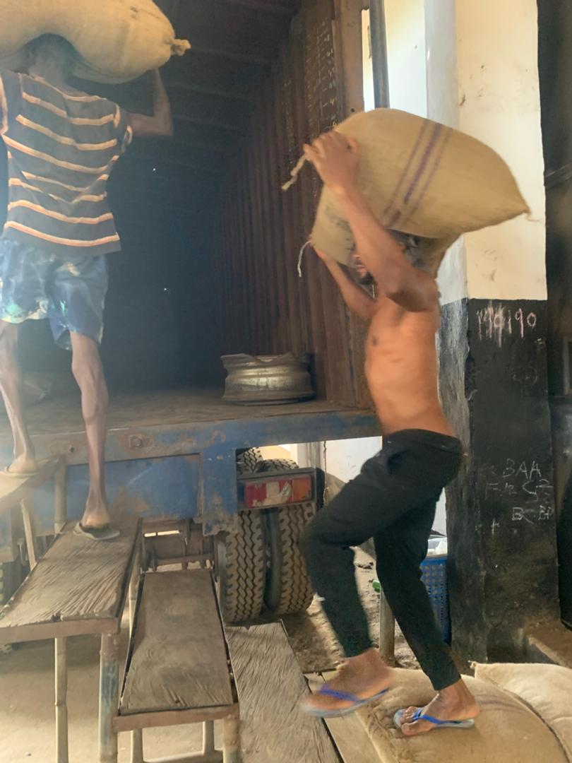 Warehouse worker lifting a sack for loading