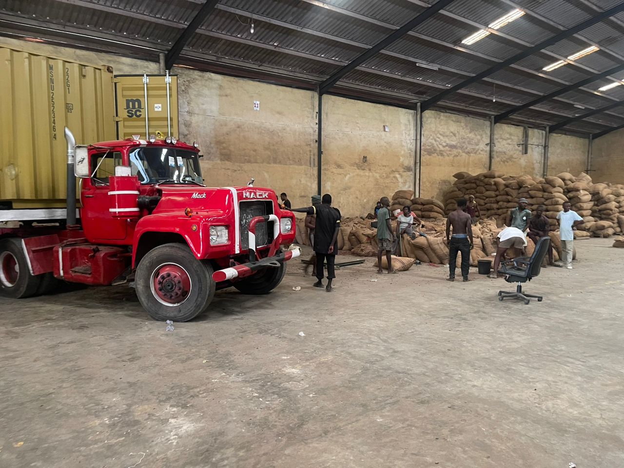 Loading truck and workers at the warehouse